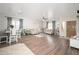 Spacious living room with wood laminate floors, neutral paint, and an open layout to dining area at 12936 W Flower St, Avondale, AZ 85392
