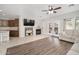 Living space with fireplace, wood laminate and tile floors, open to kitchen and patio access at 12936 W Flower St, Avondale, AZ 85392