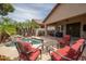 Inviting backyard pool with rock waterfall feature and covered patio seating area, perfect for outdoor entertaining at 12936 W Flower St, Avondale, AZ 85392