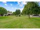 Beautiful green backyard with mature trees and lush grassy area at 13023 W Tangelo Dr, Sun City West, AZ 85375