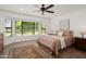 Serene bedroom with bay window, ceiling fan and plush carpeting at 13023 W Tangelo Dr, Sun City West, AZ 85375