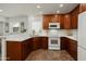 Kitchen showcases rich wood cabinetry, modern appliances, and an inviting breakfast bar at 13023 W Tangelo Dr, Sun City West, AZ 85375
