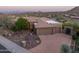 Aerial view of a stunning home with a circular driveway and lush desert landscaping at 15135 E Sundown Dr, Fountain Hills, AZ 85268