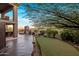 Lush backyard features a putting green, fireplace, outdoor bar, and scenic mountain views, ideal for outdoor living at 15135 E Sundown Dr, Fountain Hills, AZ 85268
