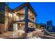 Two-story home featuring spiral staircase, outdoor kitchen, pool, lounge area, and fireplace at 15135 E Sundown Dr, Fountain Hills, AZ 85268