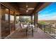Spacious covered balcony includes a dining area and comfortable seating with serene mountain views at 15135 E Sundown Dr, Fountain Hills, AZ 85268