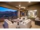 Covered balcony with cozy seating arrangement and built-in fire pit offers scenic mountain views at 15135 E Sundown Dr, Fountain Hills, AZ 85268