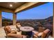 Covered balcony showcases mountain views with comfortable seating around a cozy fire pit at 15135 E Sundown Dr, Fountain Hills, AZ 85268