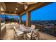 Expansive covered balcony features a dining area, seating, and scenic views of the surrounding landscape at 15135 E Sundown Dr, Fountain Hills, AZ 85268