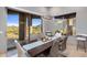 Stylish dining room featuring tile floors, deck access with mountain views, and modern light fixture at 15135 E Sundown Dr, Fountain Hills, AZ 85268