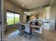Bright dining area adjacent to an island kitchen, featuring a mountain view and modern lighting at 15135 E Sundown Dr, Fountain Hills, AZ 85268