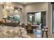 Open-concept dining room with a modern chandelier and sliding glass doors leading to a scenic outdoor area at 15135 E Sundown Dr, Fountain Hills, AZ 85268