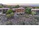 Beautiful multi-story home with large windows, pool, and mountain views surrounded by mature landscaping at 15135 E Sundown Dr, Fountain Hills, AZ 85268