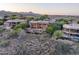 Beautiful multi-story home with large windows, pool, and mountain views surrounded by mature landscaping at 15135 E Sundown Dr, Fountain Hills, AZ 85268