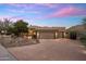 Striking home exterior featuring a circular driveway, porte-cochere, and well-maintained landscaping at 15135 E Sundown Dr, Fountain Hills, AZ 85268
