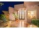 Close-up of elegant front entrance with iron double doors and stylish desert landscaping at 15135 E Sundown Dr, Fountain Hills, AZ 85268