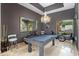 Spacious game room offers a billiard table, unique light fixture and travertine floors at 15135 E Sundown Dr, Fountain Hills, AZ 85268