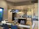 Bright kitchen with white cabinetry, stainless steel appliances, and a large center island with stone countertops at 15135 E Sundown Dr, Fountain Hills, AZ 85268