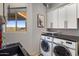 Well-organized laundry room with front-load machines and scenic outside views at 15135 E Sundown Dr, Fountain Hills, AZ 85268
