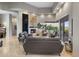 Bright living room featuring high ceilings, a modern fireplace, and a sliding glass door to a scenic balcony at 15135 E Sundown Dr, Fountain Hills, AZ 85268