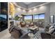 Bright living room featuring high ceilings, a modern fireplace, and a sliding glass door to a scenic balcony at 15135 E Sundown Dr, Fountain Hills, AZ 85268