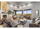 Bright living room featuring high ceilings, a modern fireplace, and a sliding glass door to a scenic balcony at 15135 E Sundown Dr, Fountain Hills, AZ 85268