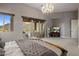 Serene main bedroom with a chandelier, a large sliding door to a scenic view, and plush carpeting at 15135 E Sundown Dr, Fountain Hills, AZ 85268