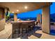 Covered outdoor kitchen with granite counters, bar seating, built-in grill, and mountain views at 15135 E Sundown Dr, Fountain Hills, AZ 85268
