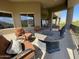 Covered outdoor patio seating area with comfortable chairs and views of the desert landscape at 15135 E Sundown Dr, Fountain Hills, AZ 85268