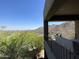 Stunning elevated view from a covered patio, showcasing the lush desert landscape and distant city lights at 15135 E Sundown Dr, Fountain Hills, AZ 85268