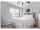 Cozy bedroom features wood-look flooring and a bright window offering great natural light at 15633 W Acapulco Ln, Surprise, AZ 85379