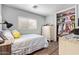 Comfortable bedroom featuring a cozy bed, a well-lit window, and convenient closet access, optimizing space and functionality at 15633 W Acapulco Ln, Surprise, AZ 85379