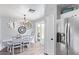Charming dining area featuring rustic decor, stylish chandelier, and ample natural light from sliding glass doors at 15633 W Acapulco Ln, Surprise, AZ 85379