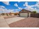 Single Gathering home featuring a 2-car garage with desert landscaping and a private entry gate at 15633 W Acapulco Ln, Surprise, AZ 85379