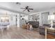 Open-concept living room featuring tile floors, ceiling fan, and a combined living and dining space at 15633 W Acapulco Ln, Surprise, AZ 85379
