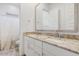 Bright bathroom with dual sinks, granite countertop, and white cabinetry at 16566 W Saguaro Park Ln, Surprise, AZ 85387