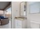 Neutral-toned powder room with granite countertop, sink, and toilet at 16566 W Saguaro Park Ln, Surprise, AZ 85387