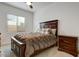 Cozy bedroom featuring dark wood accents and neutral walls at 16566 W Saguaro Park Ln, Surprise, AZ 85387