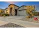 Charming single-Gathering home with stone accents, a large driveway, and a two-car garage at 16566 W Saguaro Park Ln, Surprise, AZ 85387