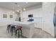 Modern kitchen featuring a large island with seating and pendant lighting, perfect for entertaining at 16566 W Saguaro Park Ln, Surprise, AZ 85387
