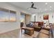 Comfortable living room with natural light and a sliding glass door to backyard at 16566 W Saguaro Park Ln, Surprise, AZ 85387