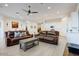 Open living room featuring a coffered ceiling, neutral walls, and leather furniture at 16566 W Saguaro Park Ln, Surprise, AZ 85387
