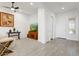 Bright living room with gray floors, a TV, and direct access to the front door at 16566 W Saguaro Park Ln, Surprise, AZ 85387
