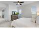 Bright main bedroom with a ceiling fan, and dresser at 16566 W Saguaro Park Ln, Surprise, AZ 85387