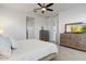 Bright main bedroom with TV console, and a ceiling fan at 16566 W Saguaro Park Ln, Surprise, AZ 85387