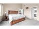 Spacious bedroom with a wood frame bed, neutral carpet, and natural lighting at 17132 E Hillcrest Dr, Fountain Hills, AZ 85268