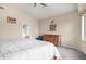 This primary bedroom has neutral colors with a peaked ceiling and an ensuite bathroom for added convenience at 17132 E Hillcrest Dr, Fountain Hills, AZ 85268
