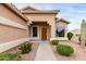 Attractive home entrance with desert landscaping, a wooden front door, and large window at 17132 E Hillcrest Dr, Fountain Hills, AZ 85268