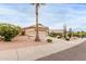 Expansive front yard showcases mature landscaping, including a palm tree, leading to a well-maintained single story home at 17132 E Hillcrest Dr, Fountain Hills, AZ 85268