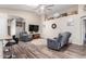 Open-concept living area with stylish bar seating, hardwood floors, reclining chairs, and vaulted ceilings at 17132 E Hillcrest Dr, Fountain Hills, AZ 85268